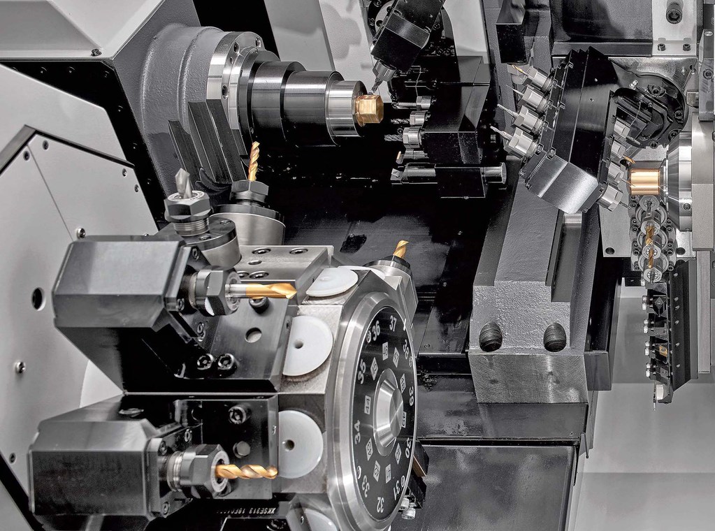 Working area of the Cincom M32, showing the B-axis gang tool post that is now programmable to enable simultaneous 5-axis CNC machining