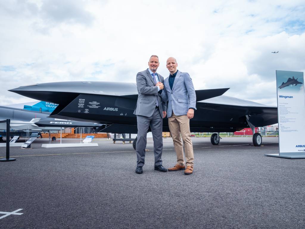 Michael Schoellhorn, CEO at Airbus Defence and Space (left), and Gundbert Scherf, co-CEO at Helsing, in front of the Airbus Wingman model